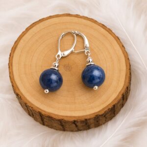 Boucles d’oreilles aventurine bleue présentées sur rondin en bois
